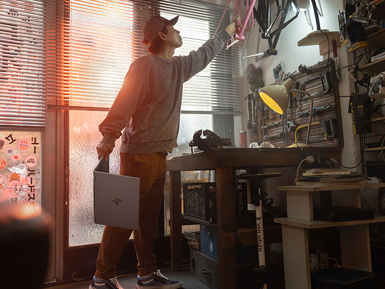 Holding Laptop In Bike Repair Shop